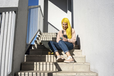 Woman sitting on staircase