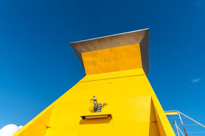 Low angle view of building against clear blue sky