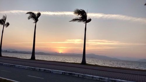 Scenic view of beach against sky during sunset