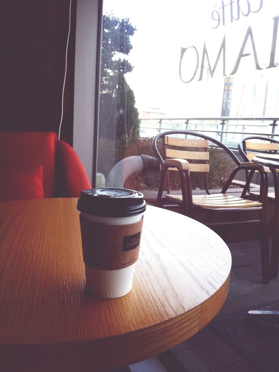 table, indoors, chair, food and drink, window, architecture, drink, cafe, built structure, restaurant, day, no people, potted plant, coffee cup, building exterior, close-up, glass - material, freshness, absence, still life