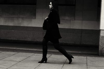 Side view of woman walking on street