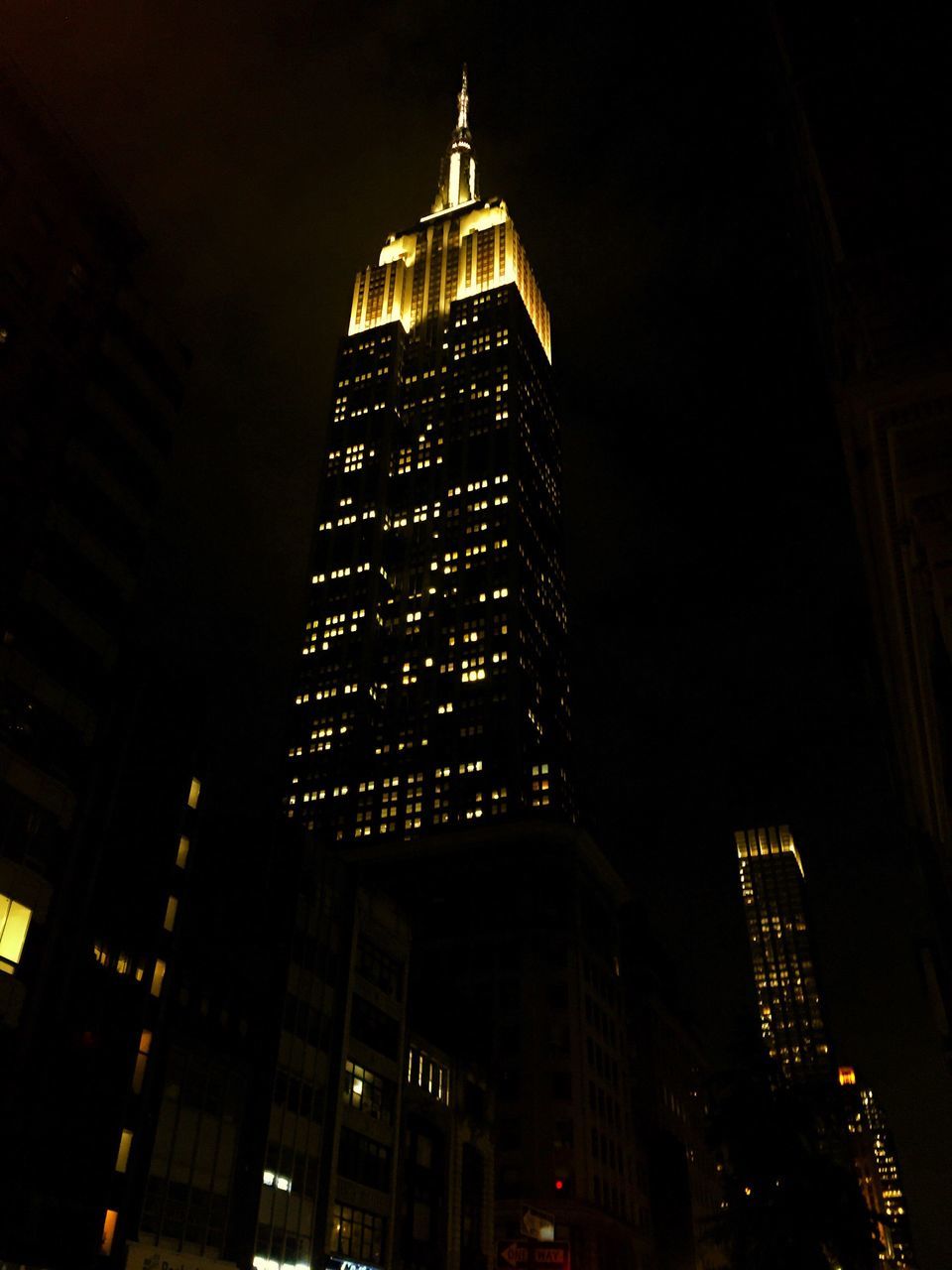 LOW ANGLE VIEW OF ILLUMINATED SKYSCRAPERS