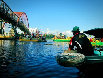 Man working in water against clear sky