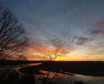 Scenic view of lake against orange sky