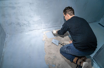 Rear view of man working at home