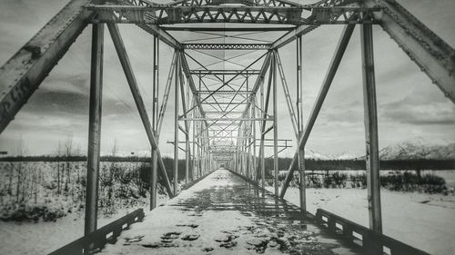 Snow on bridge against sky