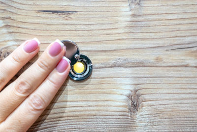 High angle view of woman hand on table