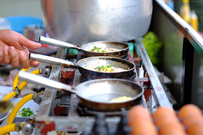 Midsection of person preparing food on barbecue grill