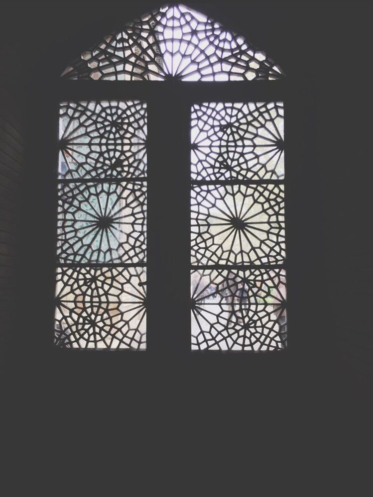 indoors, window, built structure, architecture, low angle view, pattern, design, dark, ceiling, stained glass, no people, religion, interior, skylight, silhouette, church, architectural feature, glass - material, arch, home interior