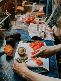 Midsection of person preparing food on table