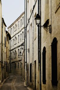 Street amidst buildings against clear sky