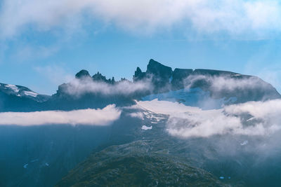 Scenic view of snowcapped mountains against clear blue sky