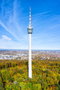 Communications tower and buildings against sky