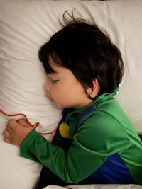 High angle view of baby sleeping in bed