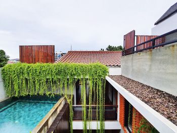 View of swimming pool by building against sky