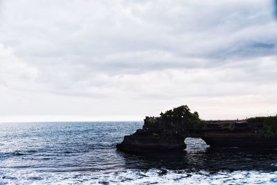 Scenic view of sea against cloudy sky