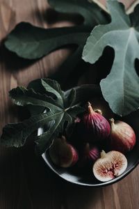 High angle view of fruits and leaves on table