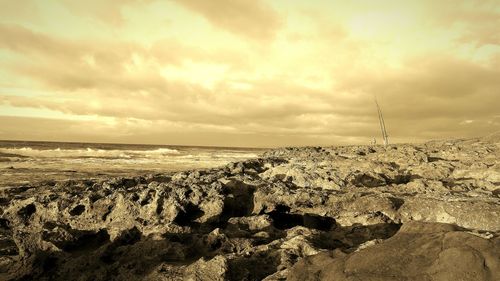 Scenic view of sea against cloudy sky