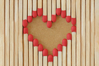 Heart made of matches on recycled paper background - love concept