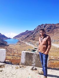 Portrait of young man standing on mountain against blue sky
beauty of sikkim india