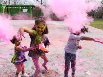 High angle view of children playing with powder paint in yard