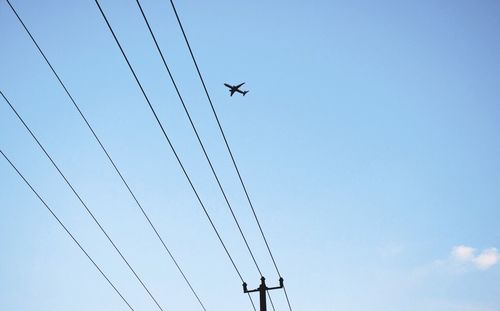 Low angle view of cables against clear blue sky