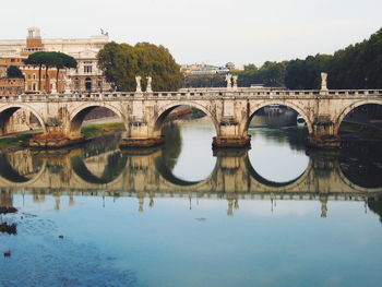 Ponte sant angelo over tiber river against sky in city