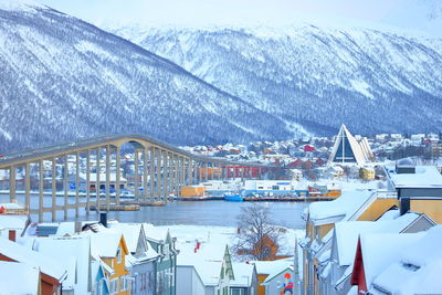 Panoramic view of buildings and snowcapped mountains during winter