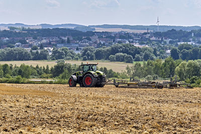 Tractor on field against sky