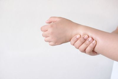 Close-up of hands over white background