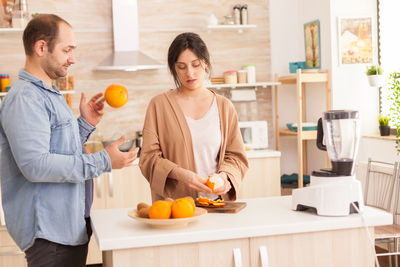 Young man preparing food on table at home