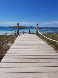 Wooden pier on sea against sky