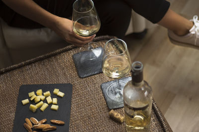 Cropped image of person with wine at table