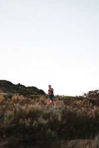 Young man standing in a sand dune