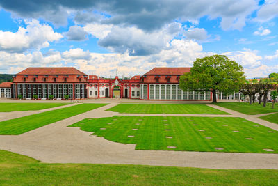 Lawn by building against sky