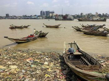 High angle view of boats moored on river in city