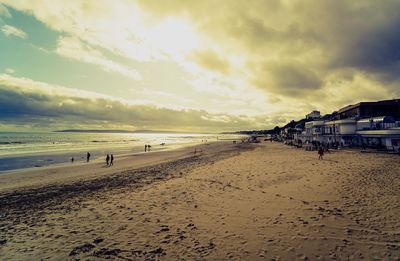 Scenic view of beach against sky during sunset