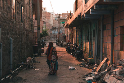 People on street amidst buildings in city