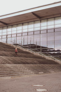 Woman walking on steps in city