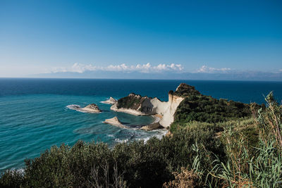 Scenic view of sea against blue sky