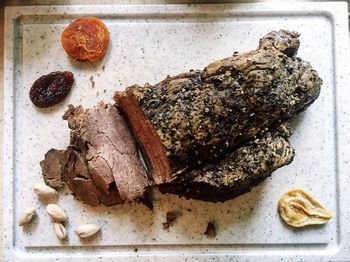 Directly above shot of beef with dried fruits served in plate