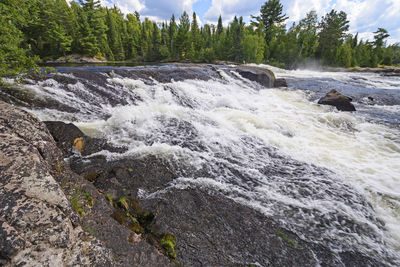 Scenic view of waterfall in sea