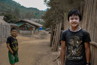 Portrait of smiling boy standing outdoors