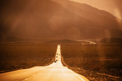 Scenic view of road against mountain