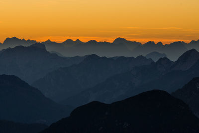 Scenic view of silhouette mountains against sky during sunset