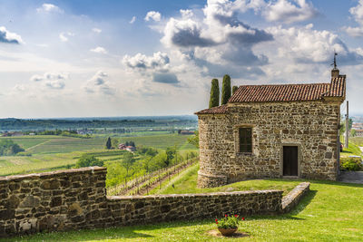 Built structure on landscape against sky