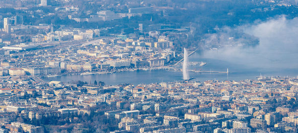 High angle view of cityscape against river