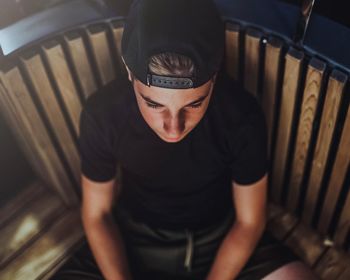 High angle view of man sitting on seat