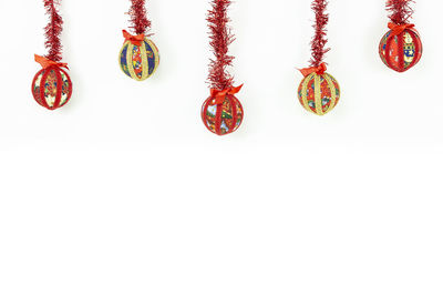 Christmas decorations hanging on white background