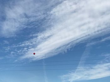 Low angle view of vapor trail against blue sky